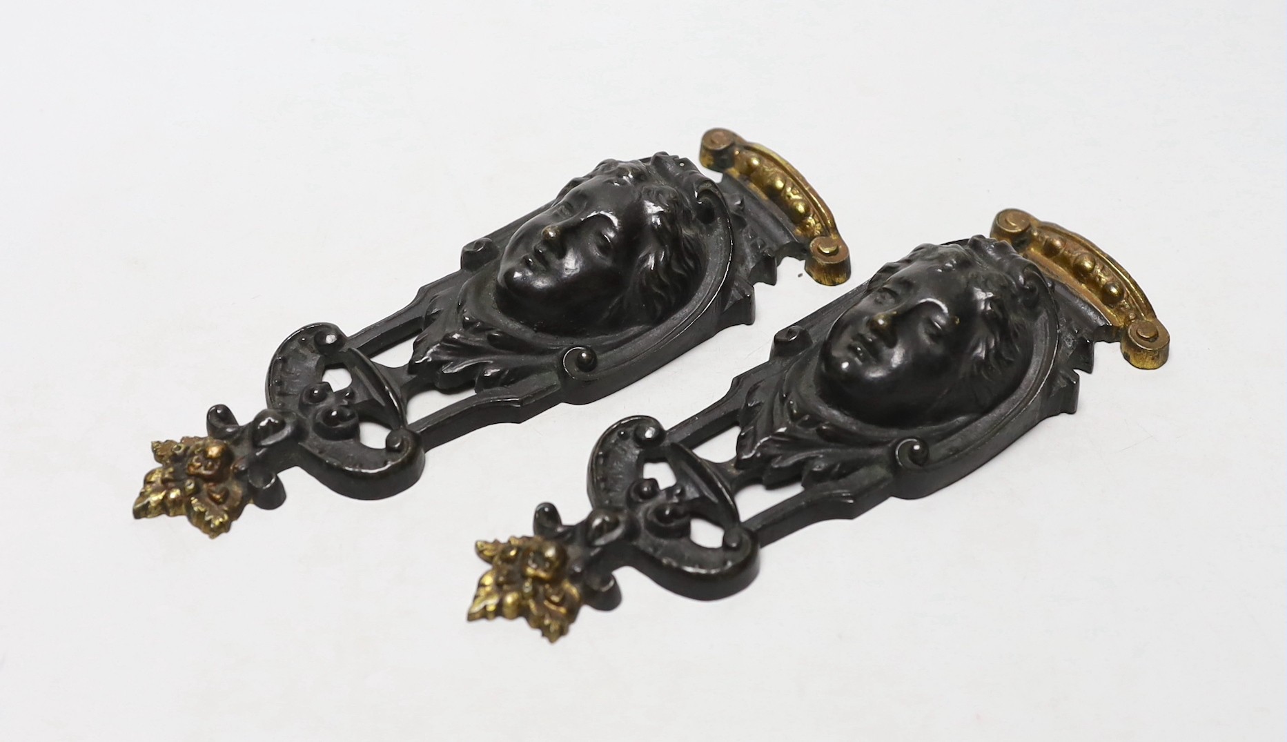 A pair of 19th century French parcel gilt furniture mounts, 18cm